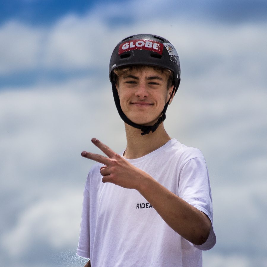 Jeune rider souriant faisant le signe de la victoire